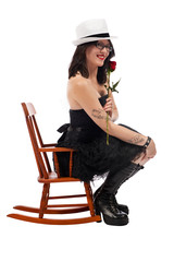 Sexy woman sitting in a kids rocking chair