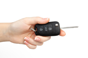 woman hand on isolated background holding car key