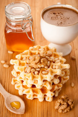 Healthy breakfast: waffles, nuts, honey and coffee