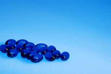 Blue pills on blue background