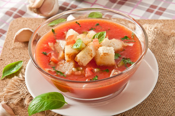 cold gazpacho with garlic croutons in glass bowl 