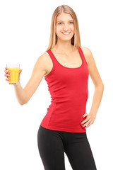 Female athlete holding a orange juice, refreshing after an exerc