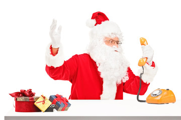 Nervous Santa Claus screaming on a telephone