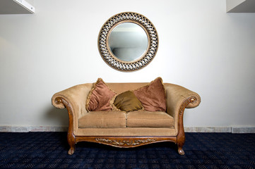 Elegant Couch Against Wall with Mirror