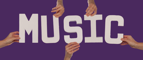 White alphabet lettering spelling MUSIC