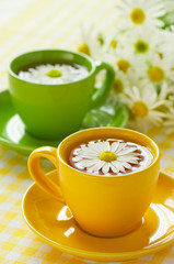 Herbal chamomile tea in a yellow cup
