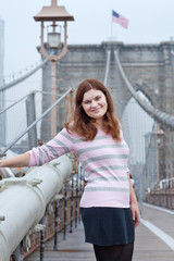 Young woman posing on Brooklyn Bridge