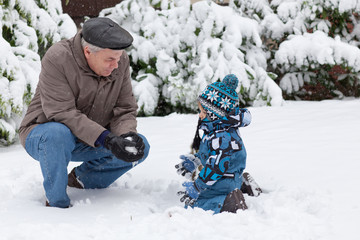 Fototapeta na wymiar Grandfather and toddler boy on winter day