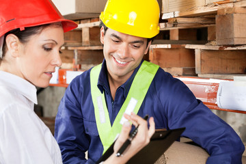 Supervisor Showing Clipboard To Foreman