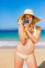 Beautiful Woman at the Beach with Camera