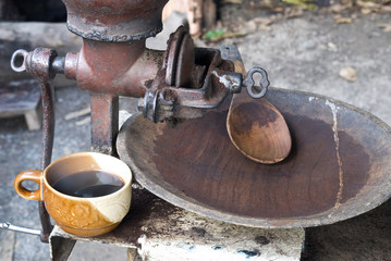 Roasted Arabica coffee grinding in old grinder in Mae Klang Luan