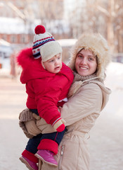 Fototapeta premium happy mother with toddler in winter