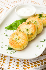 Salty cottage cheese cakes called syrniki with dill