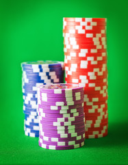 Group from chips for poker on the green background