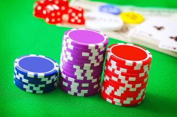Group from chips for poker on the green background