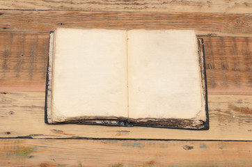 Vintage book, open, on old wooden table