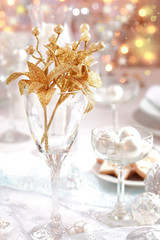 Golden branch on Christmas table