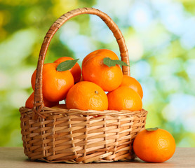tangerines with leaves in a beautiful basket,