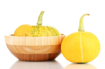 pumpkins in wooden bowl isolated on white