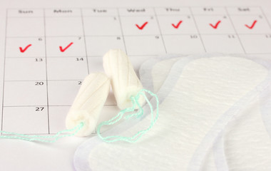 menstruation calendar with sanitary pads and tampons, close-up