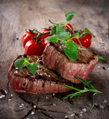 Grilled bbq steaks with fresh herbs and tomatoes