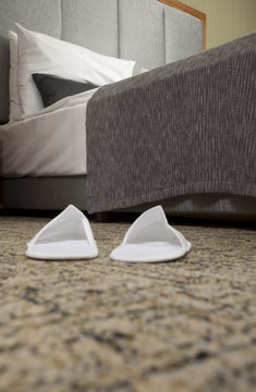 Slippers on the floor of hotel room 