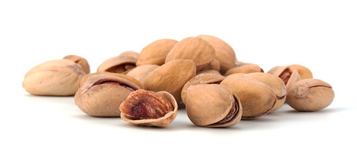 Toasted pistachios closeup on white background
