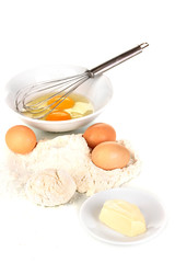 Eggs, flour and butter isolated on white