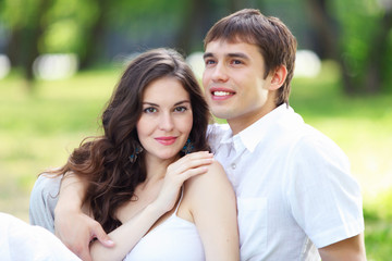 Fototapeta premium Young love Couple smiling under blue sky