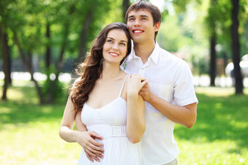 Fototapeta premium Young love Couple smiling under blue sky