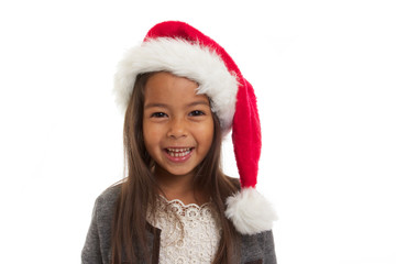 enfant souriante avec chapeau de noël