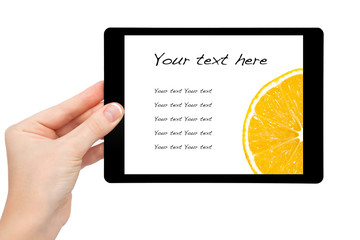 woman hand hold a mini tablet with orange on a screen