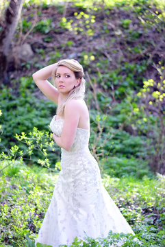 beautiful girl bride in green wood by summer