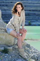 beautiful girl on stone coast near lake