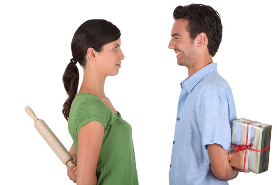 Man apologizing to woman with rolling-ping