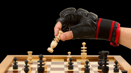 Playing chess in freefight gloves, isolated