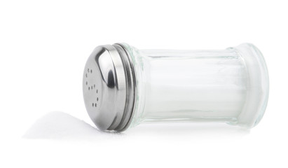 Glass saltcellar with salt on white background