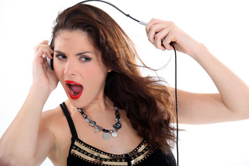 Crazy woman stretching her headphones