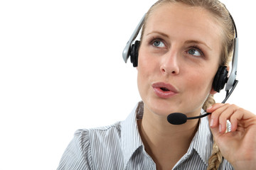 Blond call center worker helping customer over the phone