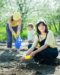   women with child works at garden