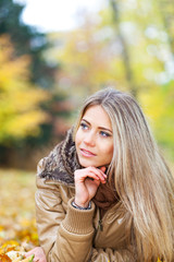 Nice woman in a park in autumn