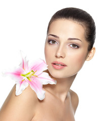 Beauty face of young woman with flower. Beauty treatment concept