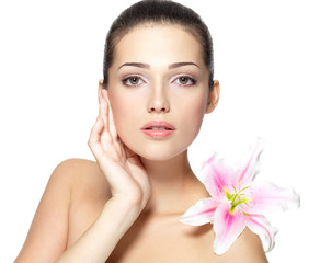 Beauty face of young woman with flower. Beauty treatment concept