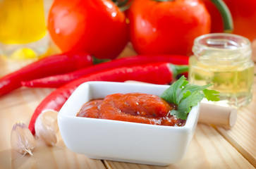 tomato and chilli  sauce in the white bowl