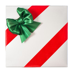 red ribbon with green bow on grey gift box