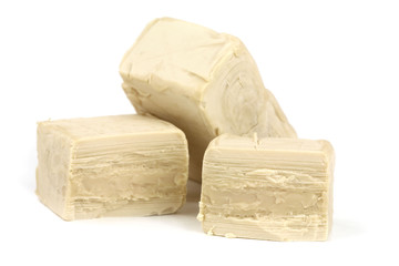 Fresh yeast cubes on white