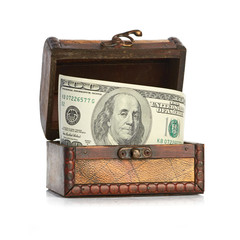 Dollar-bills in the old wooden treasure chest