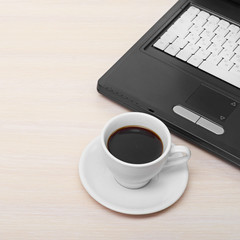 laptop with fresh cup of coffee and notebook