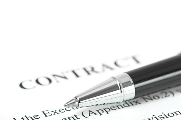 Close-up of silver pen on contract.