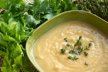 Tasty cream of celeriac soup in a green bowl